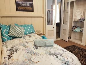 a bedroom with a bed with blue pillows at Spacious Suite in Townsville