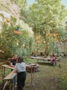 two women sitting at a picnic table in a park at La Boule d'Or - Auberge créative in Clamecy
