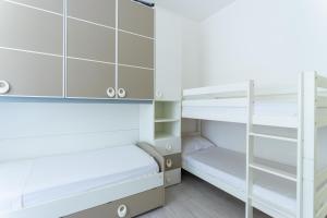 a bedroom with bunk beds and a ladder at Appartamento Ashur Mondello in Palermo +48 photos