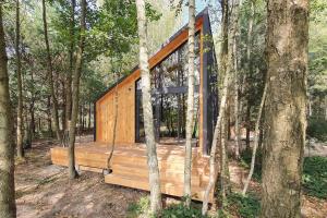 a tree house in the middle of the woods at Szumi Las 