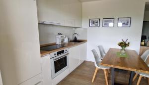una pequeña cocina con mesa de madera y encimera en Apartment Maris Nin en Nin