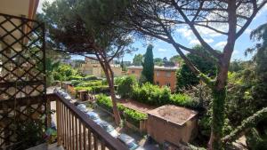 a view of a garden from the balcony of a house at Gastaldi House, EUR Mostacciano, delizioso flat in Rome
