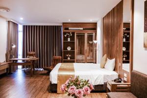 a hotel room with a bed and a desk at IRIS Hotel Hải Phòng in Hai Phong
