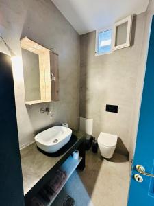 a bathroom with a sink and a toilet at Evangelia in Symi +13 photos