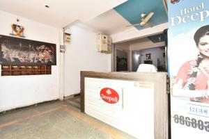 a ticket booth in a room with a sign at SPOT ON 64570 Hotel Deepali Lodging in Aurangabad