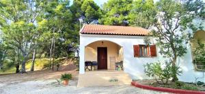 a small white house with a red roof at Vigla Village in Spartià