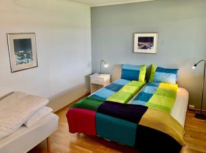 a bedroom with a bed with a colorful blanket at Villa top view Tromsø in Tromsø