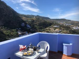 einen Tisch mit Essen auf einer blauen Wand in der Unterkunft Dar Fatima in Chefchaouen