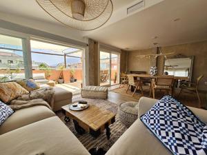 a living room with couches and a table at La Sardina de Denia in Denia
