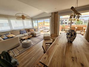 a living room with a wooden table and a couch at La Sardina de Denia in Denia
