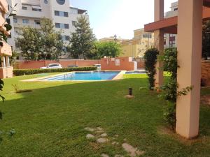 a yard with a swimming pool in a building at La Sardina de Denia in Denia