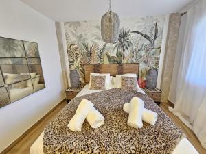 a bedroom with a leopard print bed with two pillows at La Sardina de Denia in Denia +32 photos