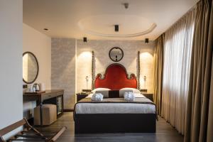 a bedroom with a large bed and a desk and mirror at Hotel Yigitalp Istanbul in Istanbul