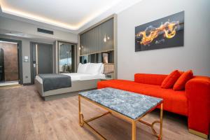 a living room with a red couch and a bed at 216 Ruby Suite in Istanbul