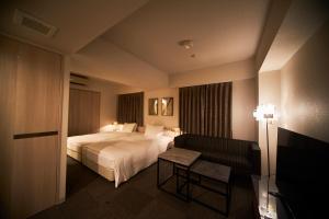 Postel nebo postele na pokoji v ubytování Roppongi Hotel S