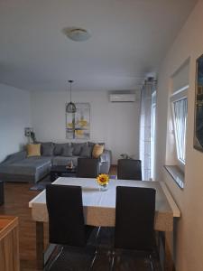 a living room with a table and a couch at Apartment Mira in Šibenik