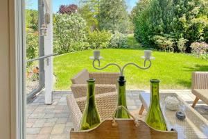 two green wine bottles sitting on a table on a patio at Ferienwohnung Am Park in Lübbenau