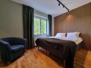 a bedroom with a bed and a chair and a window at Sankt Anna Resort in Sankt Anna