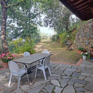 a table and chairs sitting on a stone patio at PODERE Piazza di Sopra in Reggello