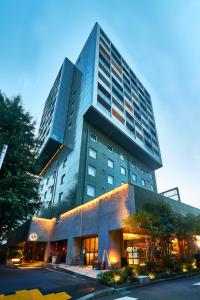 a large tall building with a building at Roppongi Hotel S in Tokyo