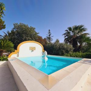 a swimming pool in the middle of a house at Villa Irene in Marsala