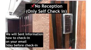 a sign on a door with a no reception sign on it at Bua House Poshtel in Chiang Mai