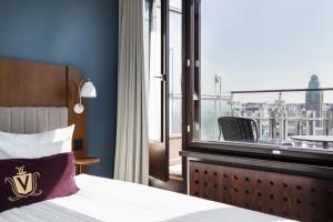 a hotel room with a bed and a large window at Original Sokos Hotel Vaakuna Helsinki in Helsinki