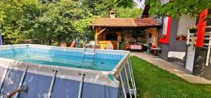 een zwembad in een achtertuin met een prieel bij Vikendica Lukavac in Lukavac