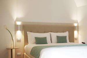 Postel nebo postele na pokoji v ubytování Hotel Ponti