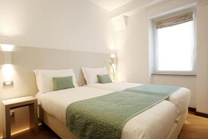 Postel nebo postele na pokoji v ubytování Hotel Ponti
