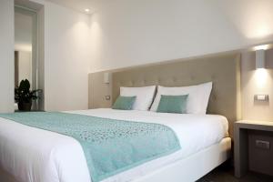 Postel nebo postele na pokoji v ubytování Hotel Ponti
