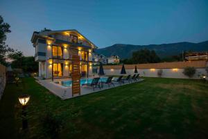 a house with a swimming pool in a yard at Villa Bahar Lux Oludeniz in Fethiye