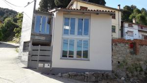 a house with glass doors on a street at La Casa de Anne Marie in Villarejo del Valle +13 photos