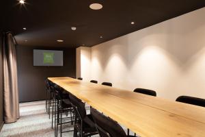 a long conference room with a long table and chairs at Ibis Styles Miramas in Miramas