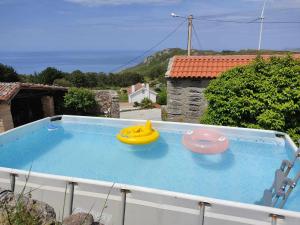 two frisbees sitting on top of a swimming pool at Grupo Gontad A Vixia do Roncudo in A Coruña