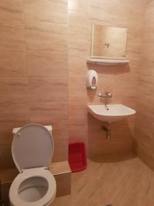 a bathroom with a toilet and a sink at Slantse in Sozopol