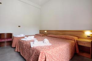 Ένα ή περισσότερα κρεβάτια σε δωμάτιο στο Residence Paradiso Bilocale 101