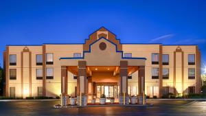 a large tan building with a large building at Best Western Inn Florence in Florence