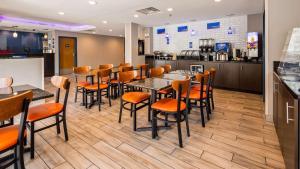 a restaurant with tables and chairs and a counter at Best Western Inn Florence in Florence