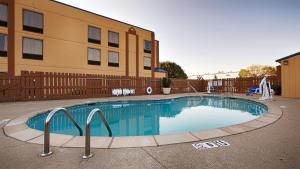 a swimming pool in front of a building at Best Western Inn Florence in Florence