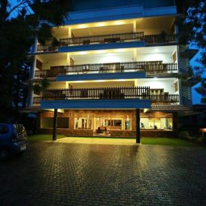 a large building with a lit up facade at night at ELEPHANT ROUTE in Thekkady