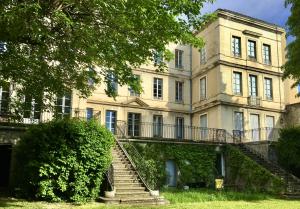 a large building with stairs in front of it at Grand appartement exceptionnel Centre-ville in Dieulefit