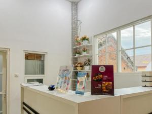 a kitchen counter with food items on it with a window at Sakura Guest House by The Lavana in Batu +14 photos