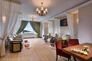 a large living room with a table and chairs at Lexis Suites Penang in Bayan Lepas