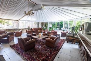a living room with couches and chairs in a tent at Château de Floure - SPA et piscine extérieure chauffée in Carcassonne