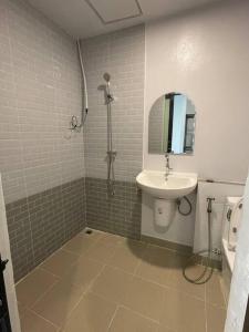 a bathroom with a sink and a toilet and a mirror at 33 Avenue in Bangkok