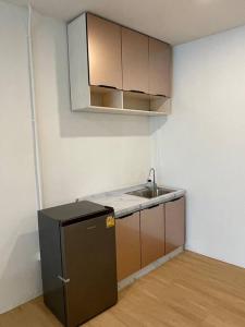 a small kitchen with a sink and a refrigerator at 33 Avenue in Bangkok