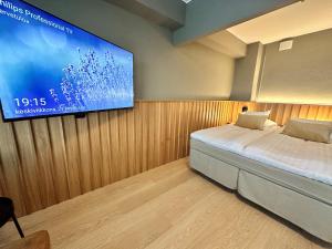 a bedroom with a bed and a tv on a wall at Park Hotel Tornio in Tornio