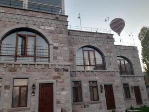 un edificio con un globo de aire caliente en el cielo en Zultanite Cappadocia Hotel en Nevşehir