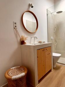 a bathroom with a sink and a mirror at Palmeirinha Guest House in Sintra